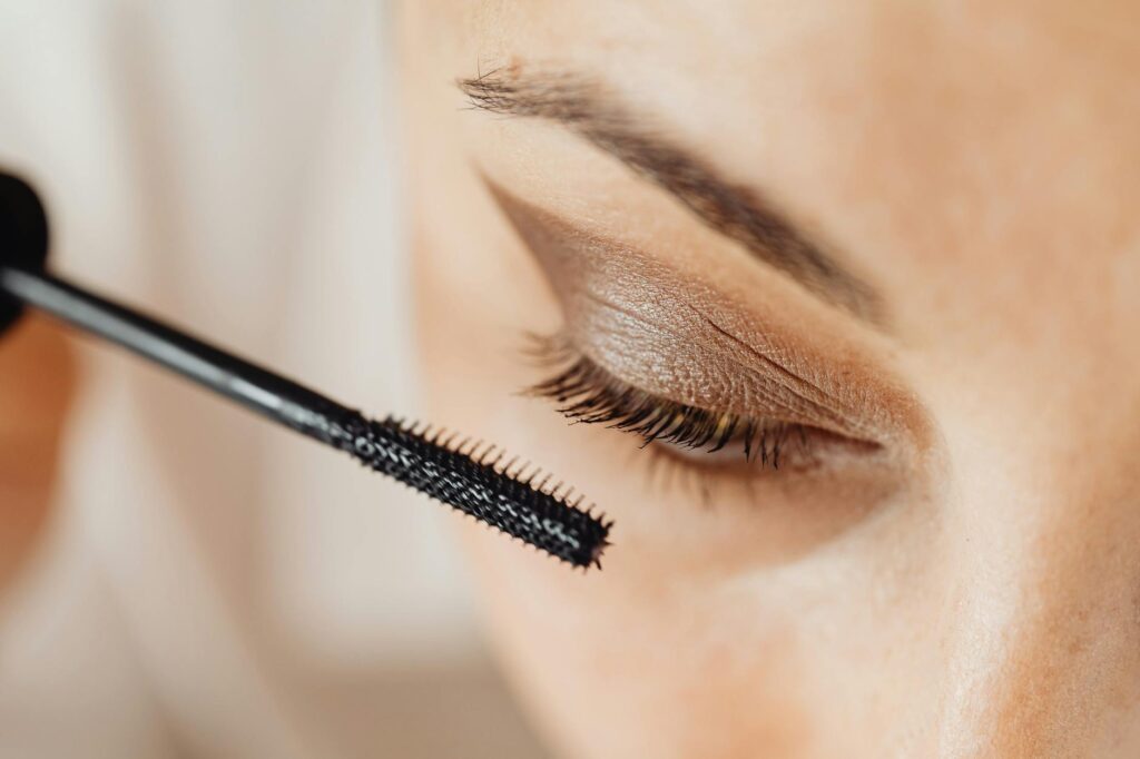 a woman applying best mascara for dry eyes