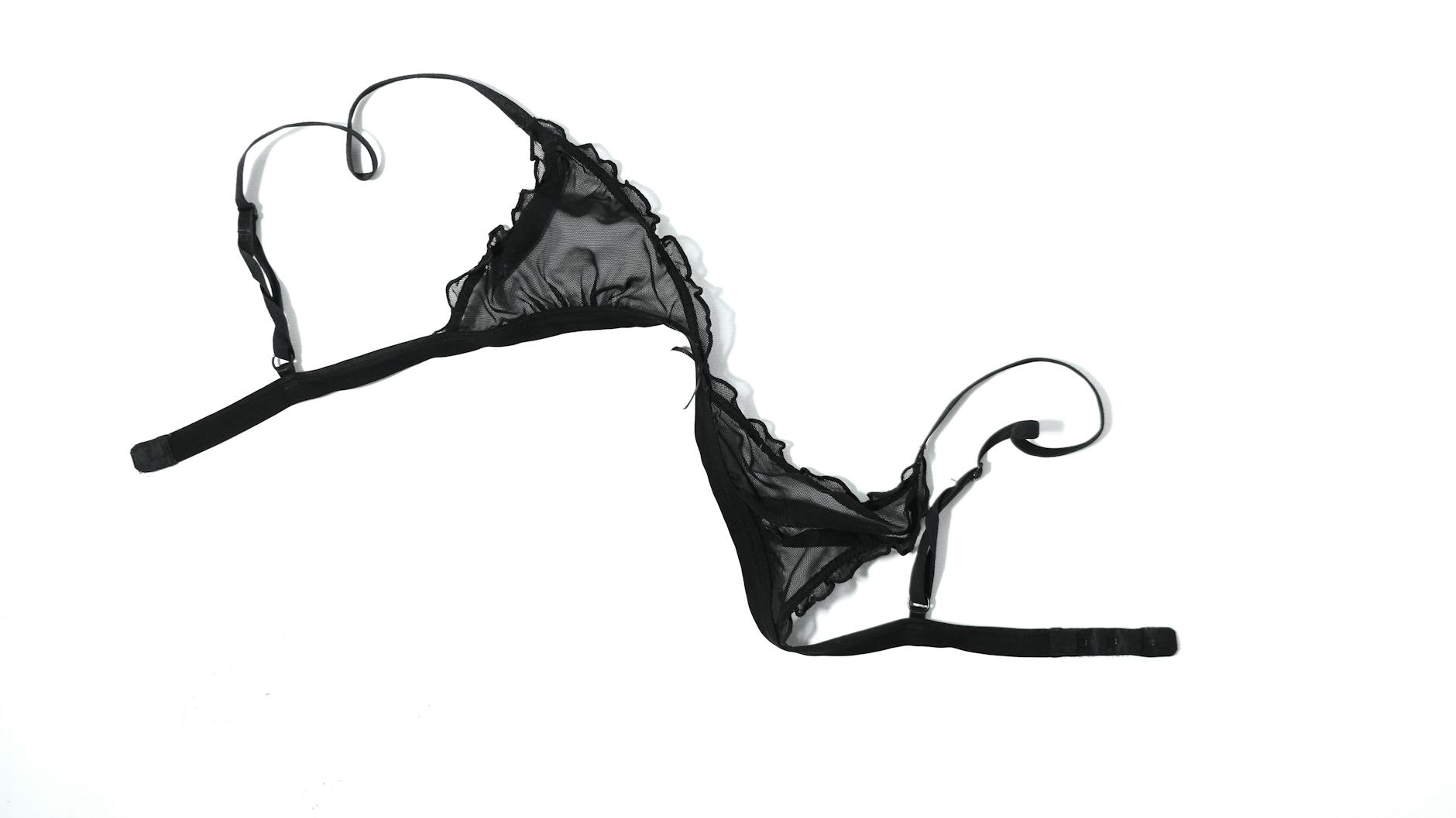 NYLON UNDERWEAR black lace bra on white background