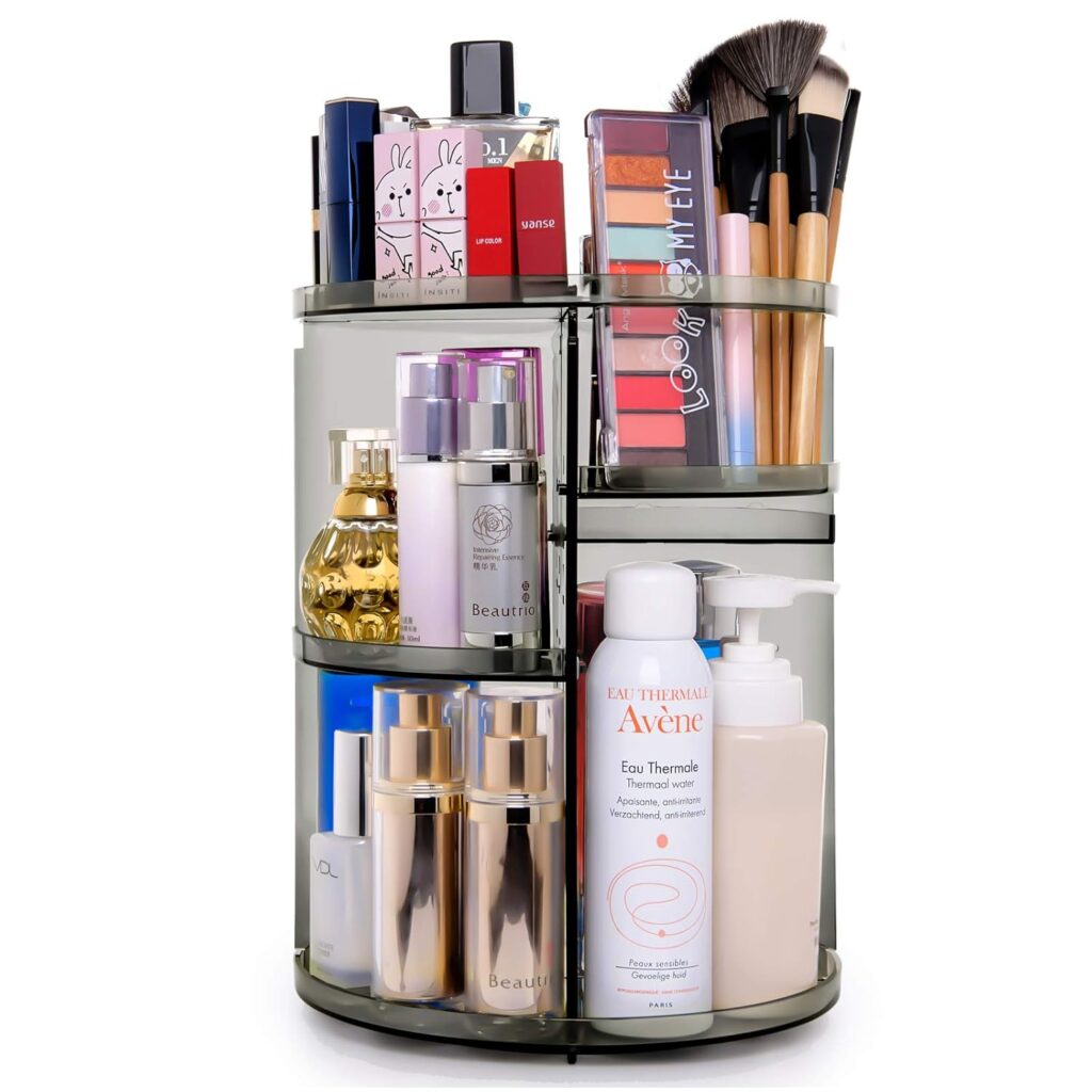 A stylish makeup organizer with clear acrylic compartments holding various beauty products on a neat vanity.