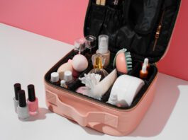 A stylish makeup organizer with clear acrylic compartments holding various beauty products on a neat vanity.