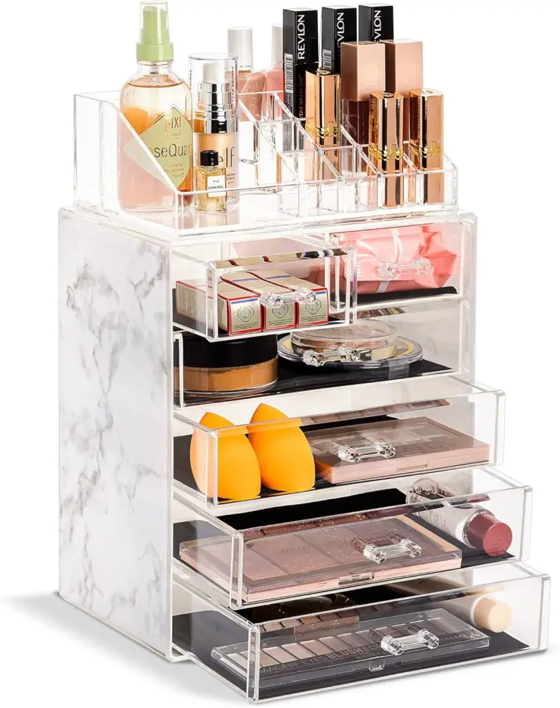 A stylish best makeup organizers with clear acrylic compartments holding various beauty products on a neat vanity.