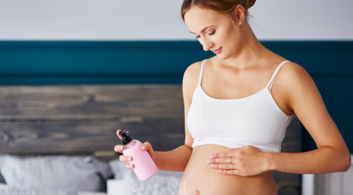 Non Toxic Skincare for Pregnancy: Safe Products & Ingredients Every Mom Should Know Young pregnant women applying cream on her belly