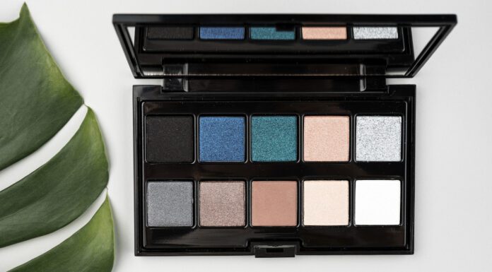 Best Eyeshadows for Blue Eyes: A Comprehensive Guide to Enhancing Your Natural Gaze Blue‑eyed woman applying the best eyeshadows for blue eyes from a flattering color palette